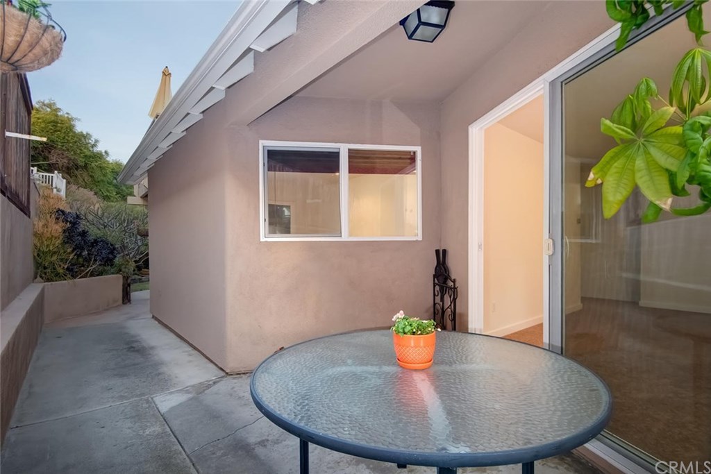 34096 El Contento Dana Point, CA 92629 - Photo 26 of 43 Enjoy the cozy covered patio on the side yard adjacent to the living room...or consider enclosing for additional indoor living space!