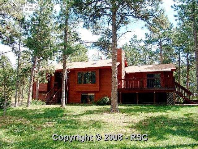 8025 Swan Road Colorado Springs, CO 80908 - Photo 11 of 15 Front view of home perfectly situated amongst the trees.