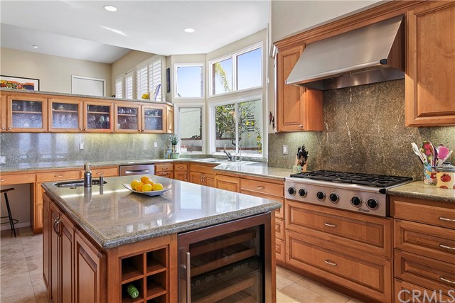 625 Avenida Acapulco San Clemente, CA 92672 - Photo 19 of 48 BUILT-IN WINE FRIDGE, SECOND ISLAND SINK, WINE STORAGE, CUSTOM CABINETS, SOFT-CLOSE DRAWERS, LOTS OF STORAGE INCLUDING DEEP POTS-AND-PANS DRAWERS, GRANITE COUNTER TOPS, 6-BURNER STOVE, DRAWER-STYLE DISHWASHER