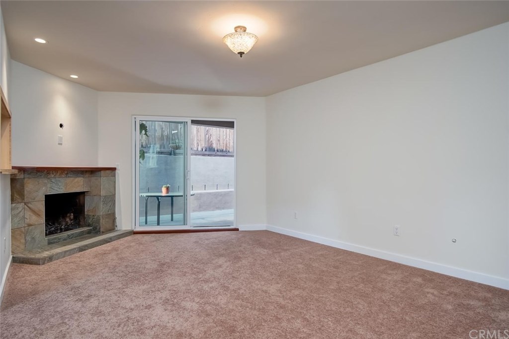 34096 El Contento Dana Point, CA 92629 - Photo 12 of 43 Newly carpeted Living Room with cozy wood & gas burning fireplace, recessed lighting adjacent to kitchen and covered outdoor side patio.