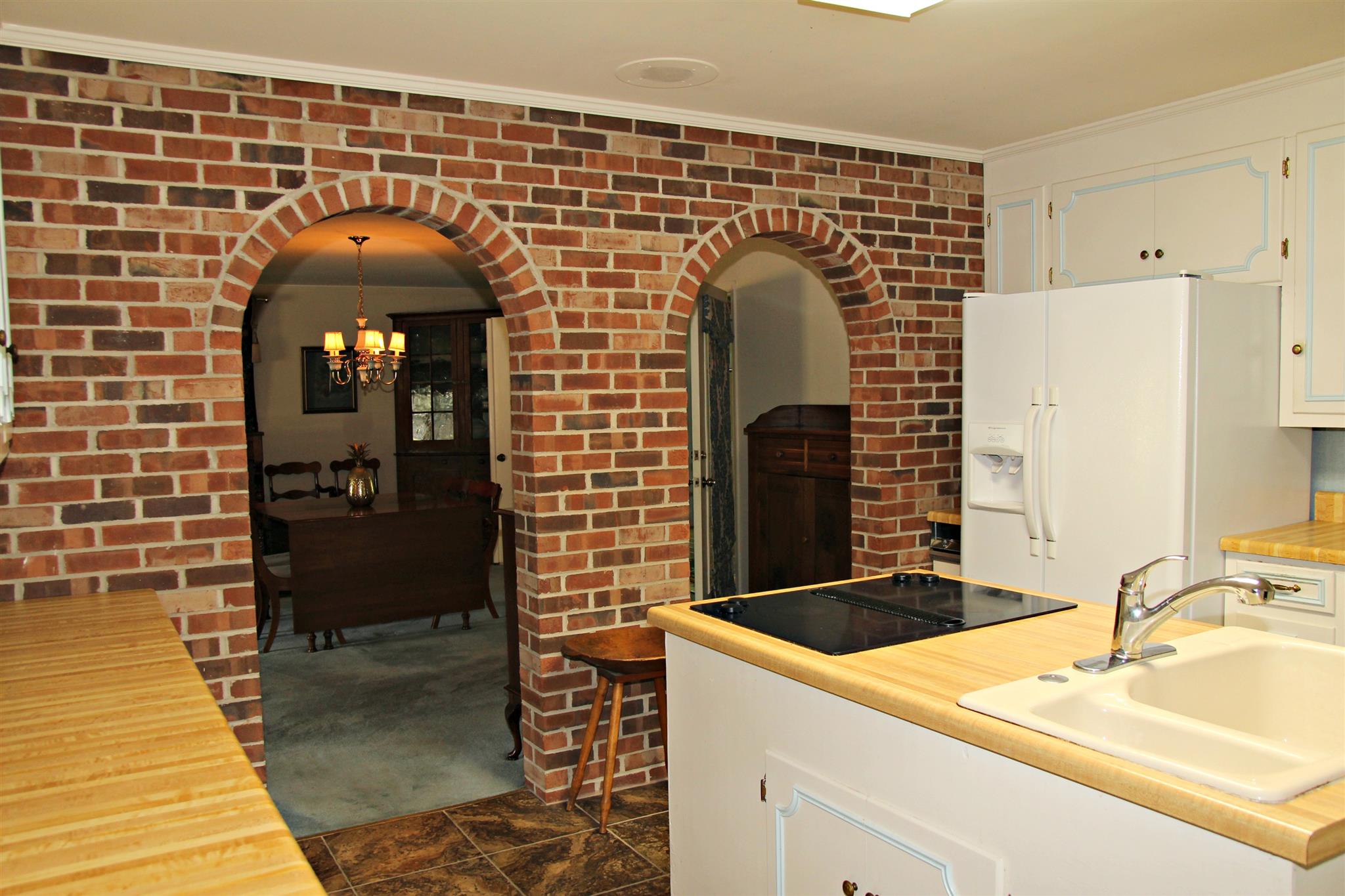 300 Kippsford Pond Road Columbia, TN 38401 - Photo 12 of 36 Brick wall separates living area and kitchen.