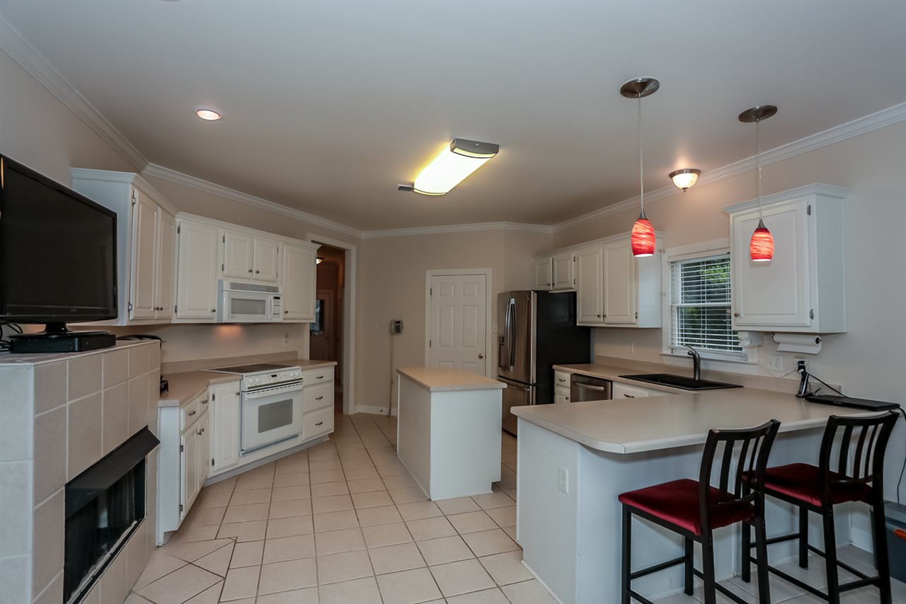 458 Duscoe Street Collierville, TN 38017 - Photo 9 of 25 Kitchen work area and the breakfast bar. Plenty of room for barstools! Kitchen also has a fireplace!!!