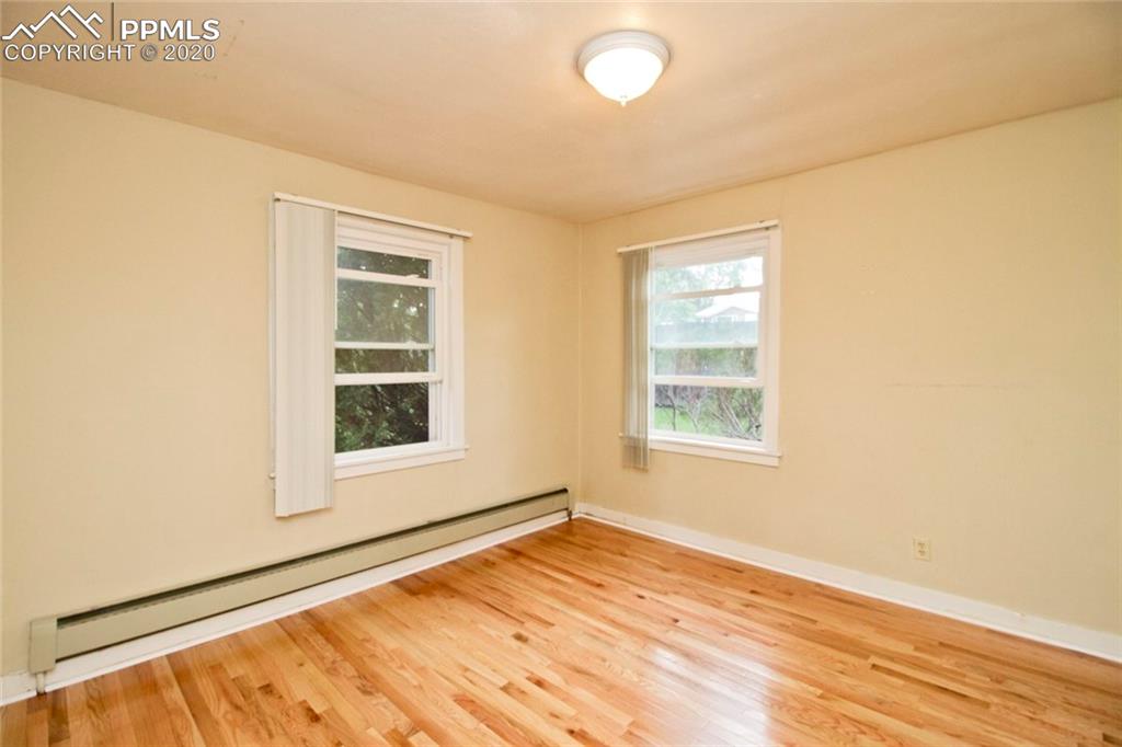 1132 Alexander Road Colorado Springs, CO 80909 - Photo 16 of 26 Second bedroom with stunning floors
