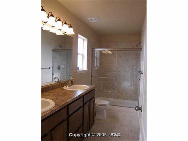 9498 Rockingham Drive Peyton, CO 80831 - Photo 10 of 15 Adjoining master bath with raised vanity, tile floors and a nice oversized shower.