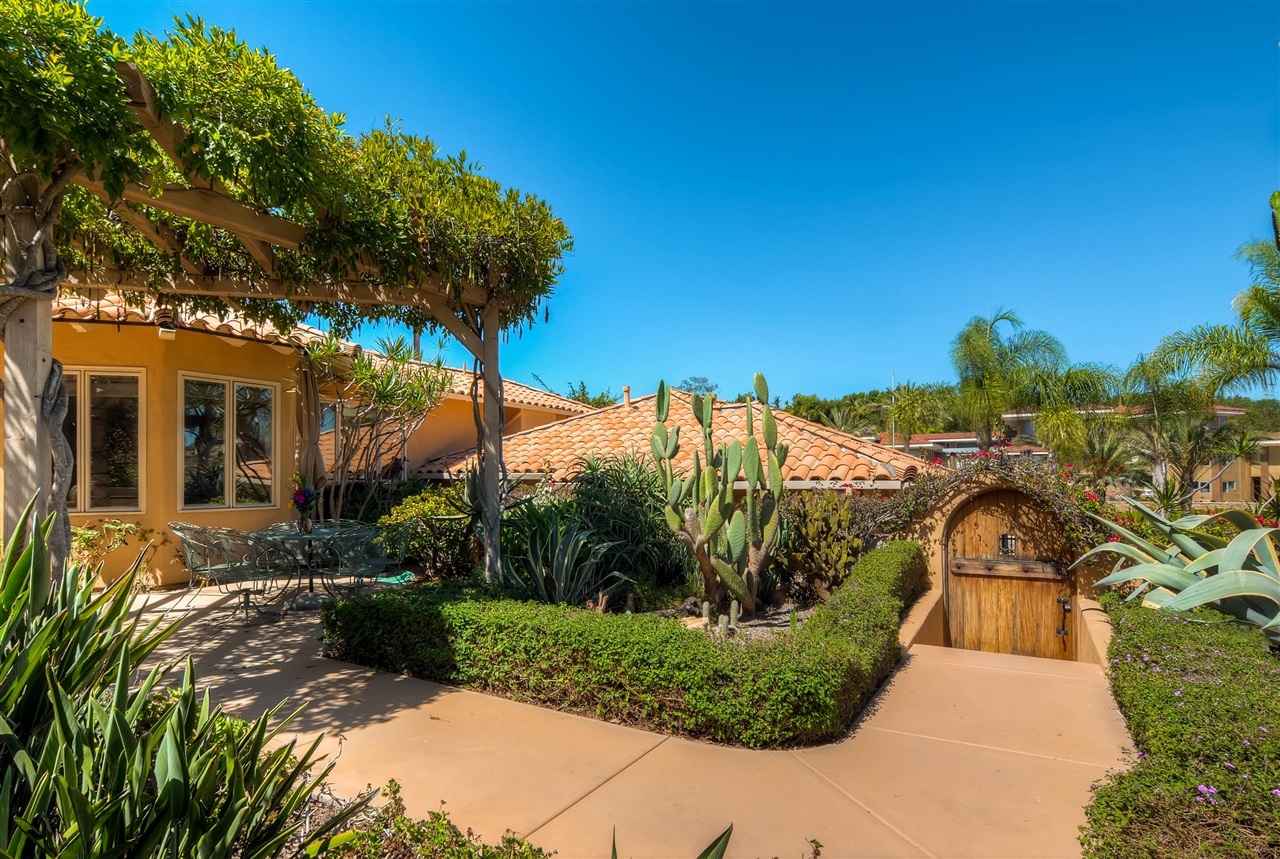 14888 Las Mananas Rancho Santa Fe, CA 92067 - Photo 11 of 25 There are many garden areas and this wooden door is a nice architectural feature. It leads to the driveway and garage.