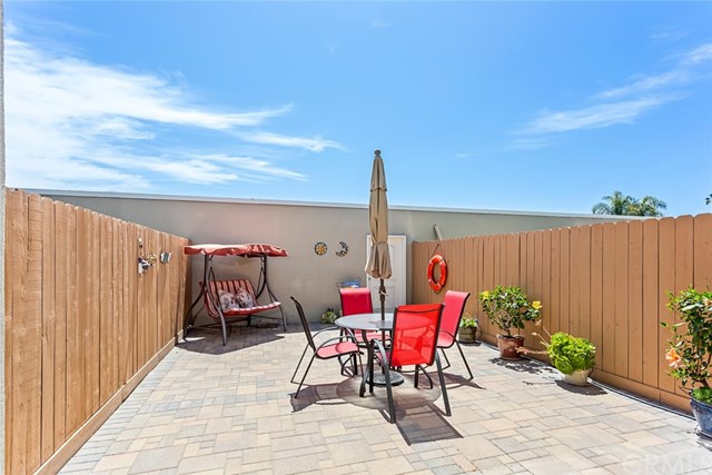 4002 Aladdin Drive Huntington Beach, CA 92649 - Photo 15 of 55 Yes, this patio is huge! Owners have replaced the fencing, installed pavers, and installed a drip system for your favorite plants! (The white door in the background opens to your 2-car garage.)