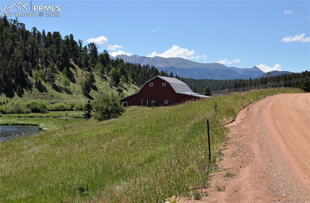 87 Apache Trail Divide, CO 80814 - Photo 12 of 20 Looking south towards Pikes Peak (just behind the trees to the left) from the western shore of Burgess Reservoir along Spring Valley Drive.