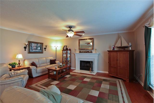 1939 Portway Road Spring Hill, TN 37174 - Photo 1 of 9 SPACIOUS LIVING ROOM FEATURES A WOODBURNING FIREPLACE, CEILING FAN AND IS OPEN TO THE KITCHEN & BREAKFAST AREA