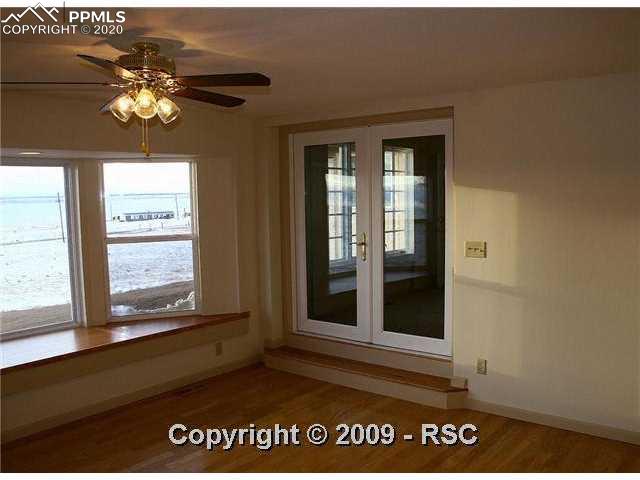 9065 Soap Weed Road Calhan, CO 80808 - Photo 5 of 15 Family room has wood floors, french doors and bay window