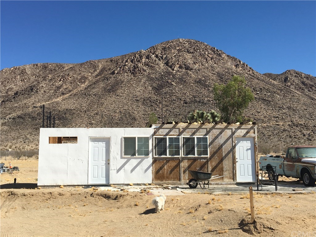 59175 Rocky Acres Road Landers, CA 92285 - Photo 1 of 1 Your weekend getaway!! This view is looking north to Goat Mountain. Owner lives in the right side and to the left is the bedroom/bathroom addition that was not completed.