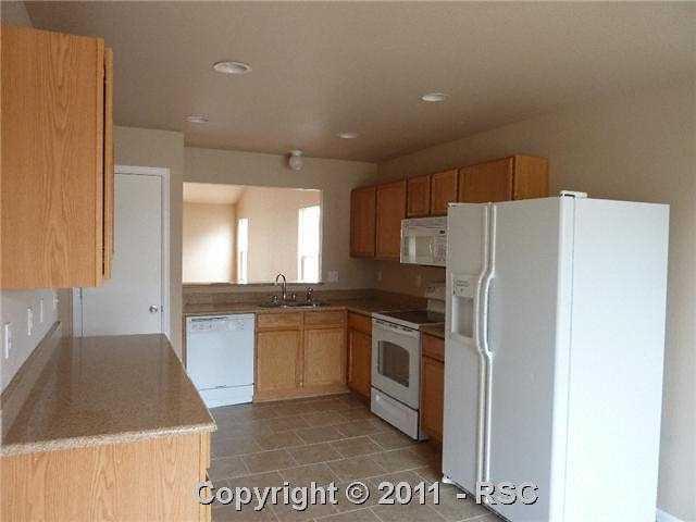 12337 Crystal Downs Road Peyton, CO 80831 - Photo 2 of 13 Updated kitchen includes new Granite Counters, Ceramic Tile Flooring and a side by side fridge