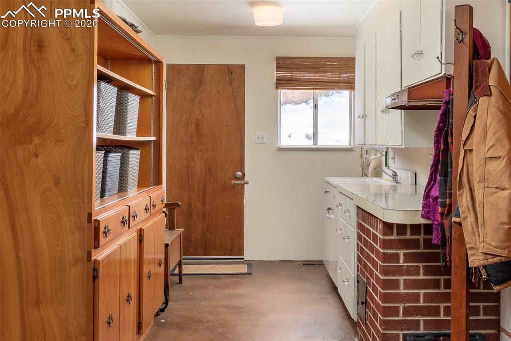 8715 Chipita Park Road Cascade, CO 80809 - Photo 27 of 33 Additional storage in the mudroom with sink.