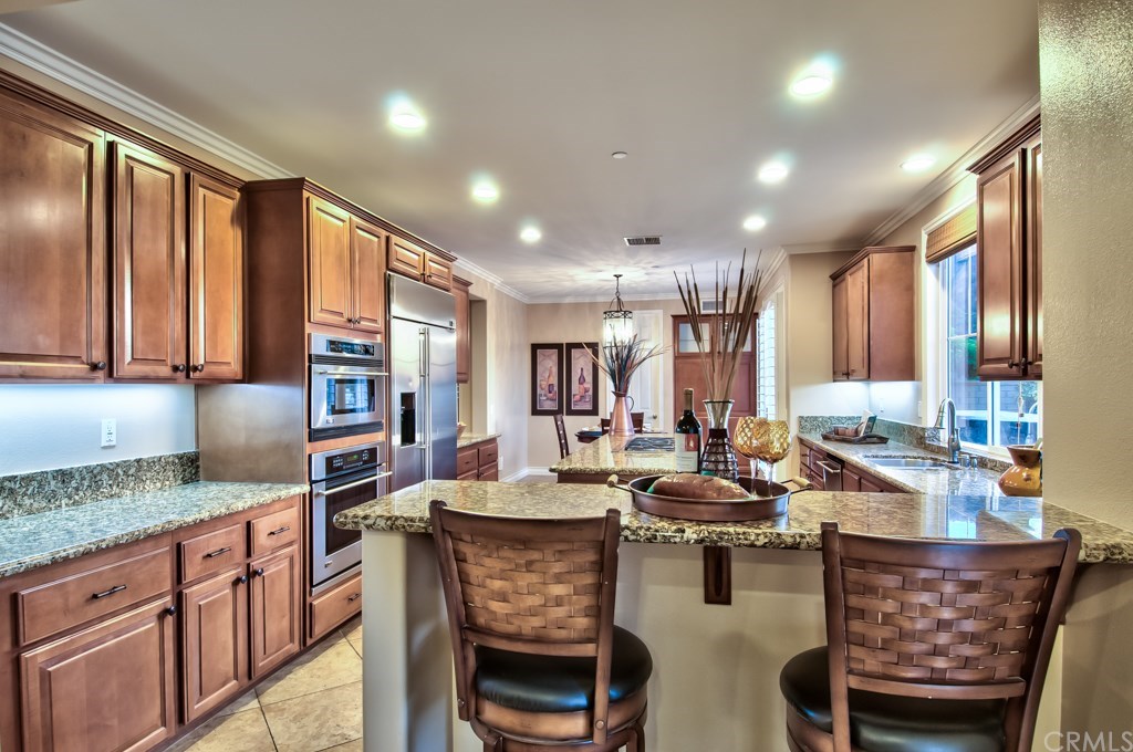 2148 Sageleaf Circle Corona, CA 92882 - Photo 10 of 74 The chef’s kitchen is outfitted with all the amenities you desire, including granite countertops, stainless steel appliances with a built-in fridge, center island, and butler’s and walk-in pantries.