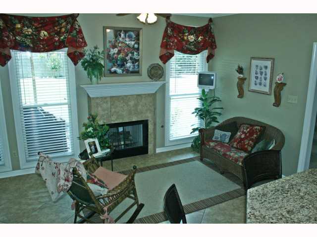 745 Coleherne Road Collierville, TN 38017 - Photo 4 of 12 Inviting keeping room with cozy fireplace, wall of windows and large eat in kitchen area. Perfect spot for guest to sit and visit while dinner is cooking. New tile flooring was recently installed.