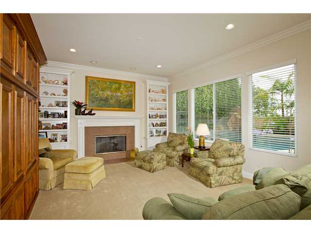 5255 Greenwillow Lane San Diego, CA 92130 - Photo 6 of 25 Family Room with Fireplace and View of the Pool