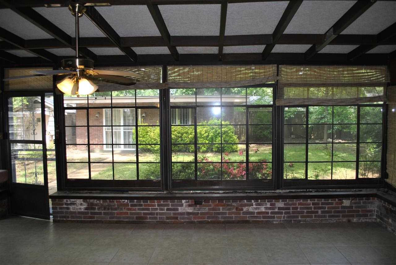 1556 South Perkins Road Memphis, TN 38117 - Photo 5 of 14 Sunroom looks out into cute, little backyard with several storage buildings