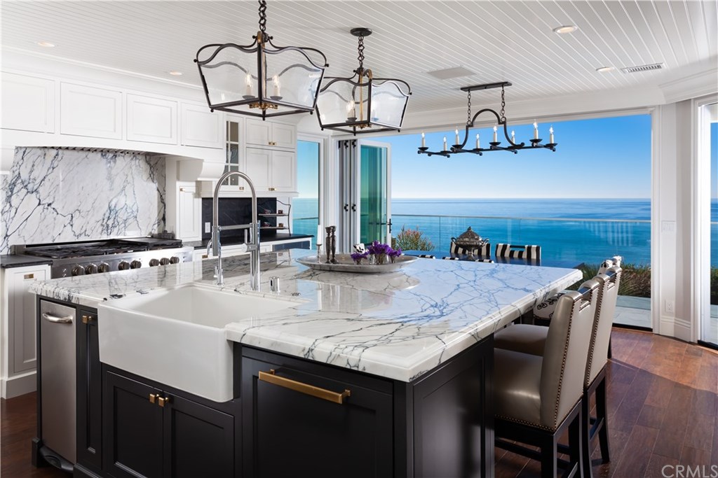34861 Doheny Place Dana Point, CA 92624 - Photo 6 of 32 Dream kitchen with Large marble countertop island and sliding doors to welcome in the panoramic coastline view.