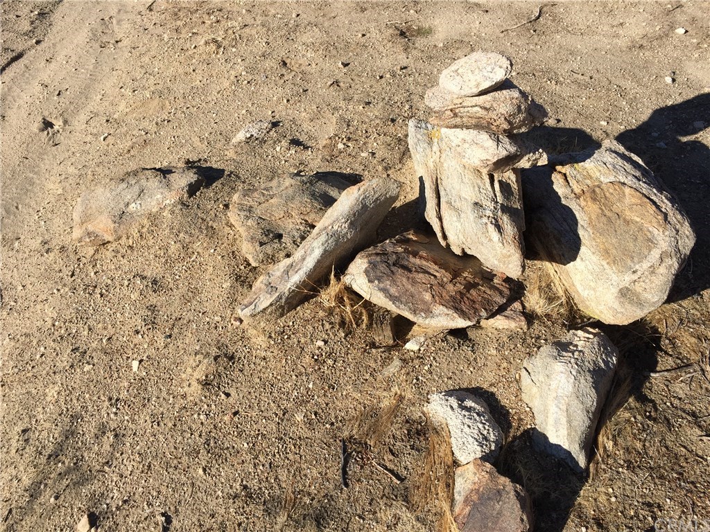 8140 Skyline Drive Joshua Tree, CA 92252 - Photo 8 of 27 See the survey stake in the center. This is the middle marker of the western boundary for the five acres. Contact agent for a parcel map and complete details.