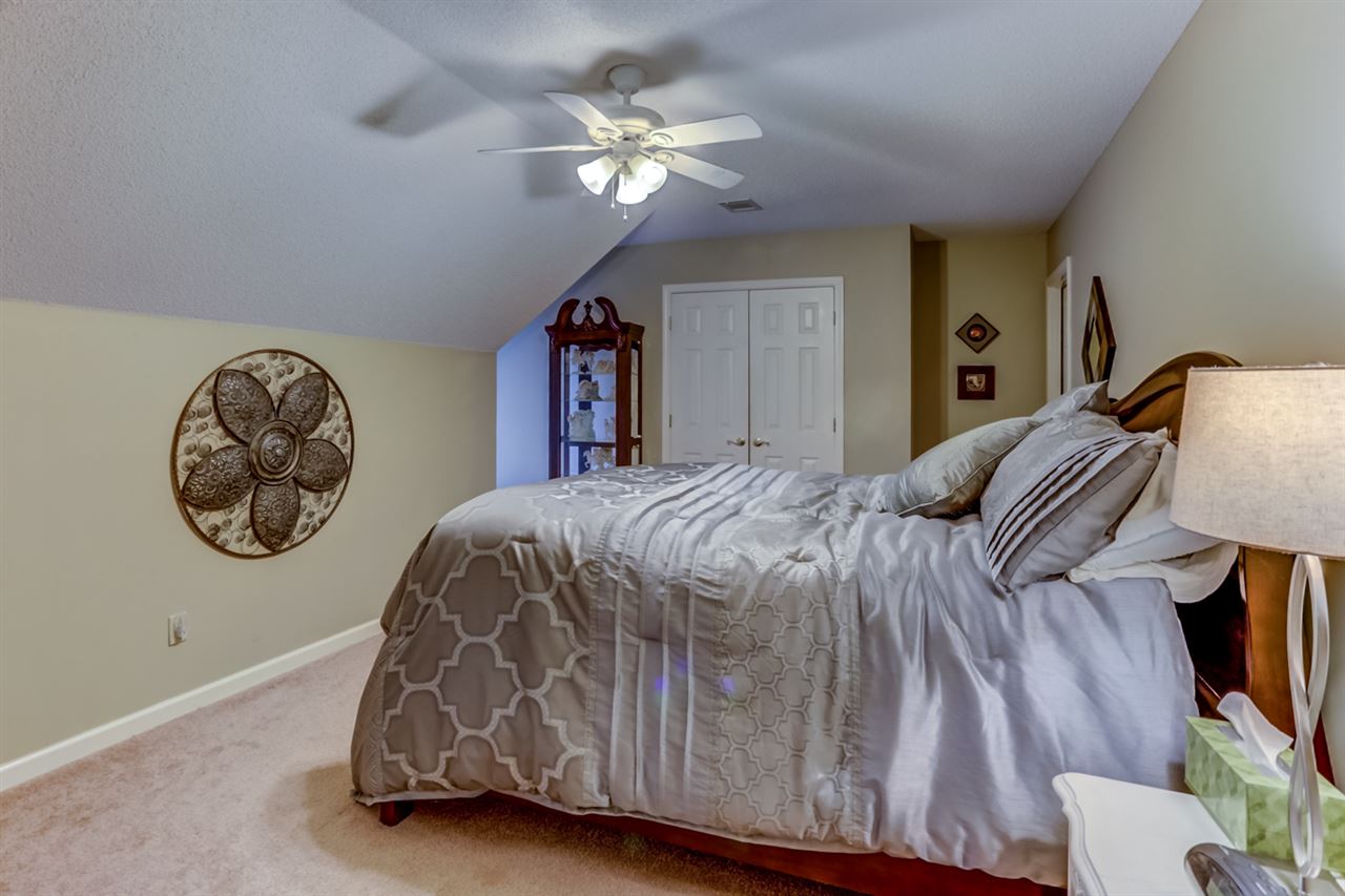 6846 Tree Spring Cove Bartlett, TN 38135 - Photo 19 of 25 This home offers three additional bedrooms upstairs. Each comes complete with plush carpeting, cooling ceiling fans, and closets.