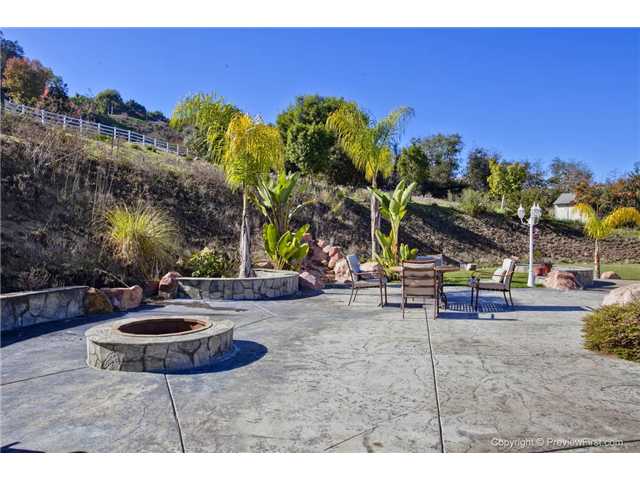 4948 Sleeping Indian Road Fallbrook, CA 92028 - Photo 21 of 25 Fire Ring, Stamped Concrete, Large Decorative Rocks Add to the Park-Like Backyard