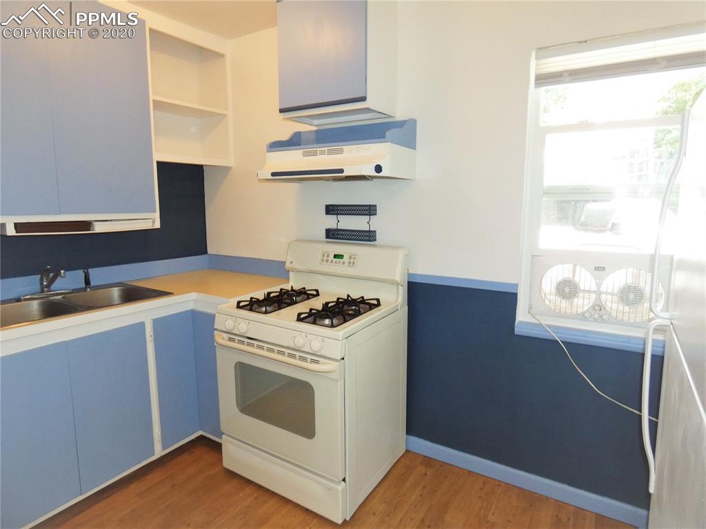 802 Sunset Road Colorado Springs, CO 80909 - Photo 9 of 17 Kitchen with updated gas oven/range, sink and refrigerator!