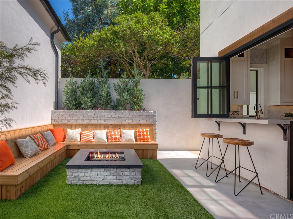 559 31st Street Manhattan Beach, CA 90266 - Photo 11 of 49 Backyard fire pit with seating, low maintenance artificial turf, indoor/outdoor bar & entertainment area that opens to backyard.