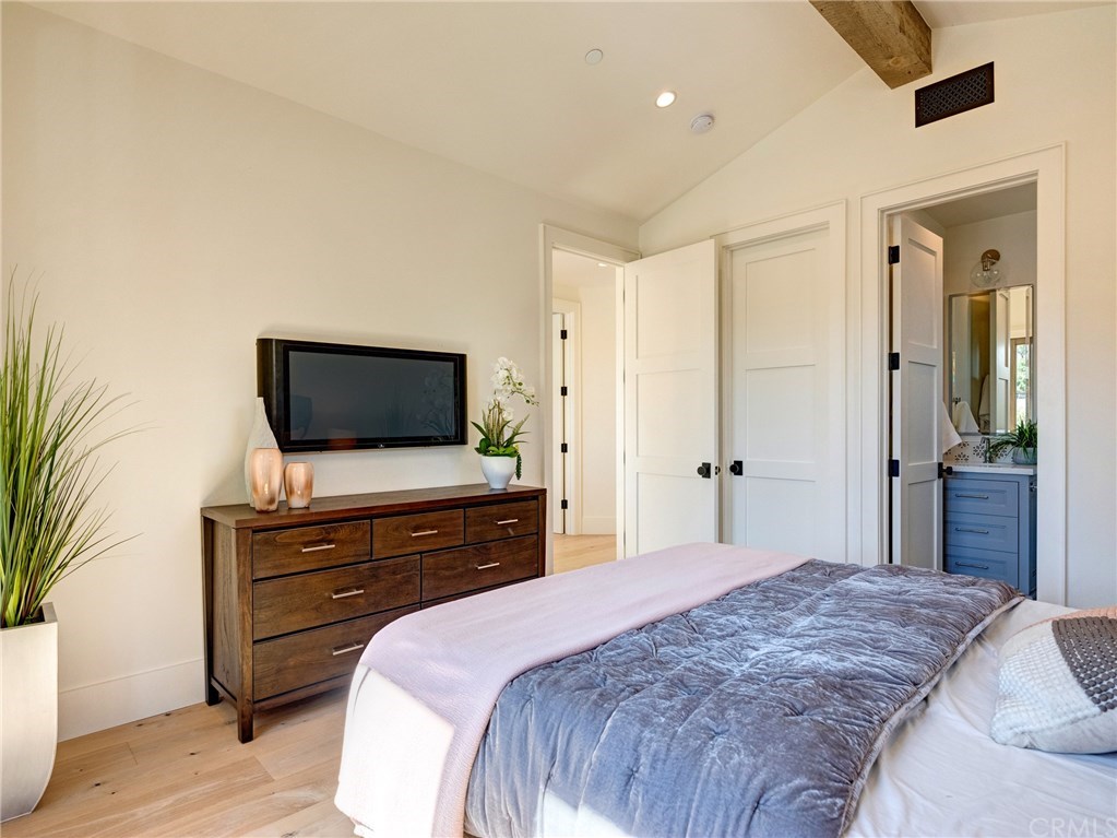 559 31st Street Manhattan Beach, CA 90266 - Photo 34 of 49 Upstairs bedroom suite with Juliet balcony, Trestlewood accent wood beam, whole home surround sound, and en-suite bathroom.