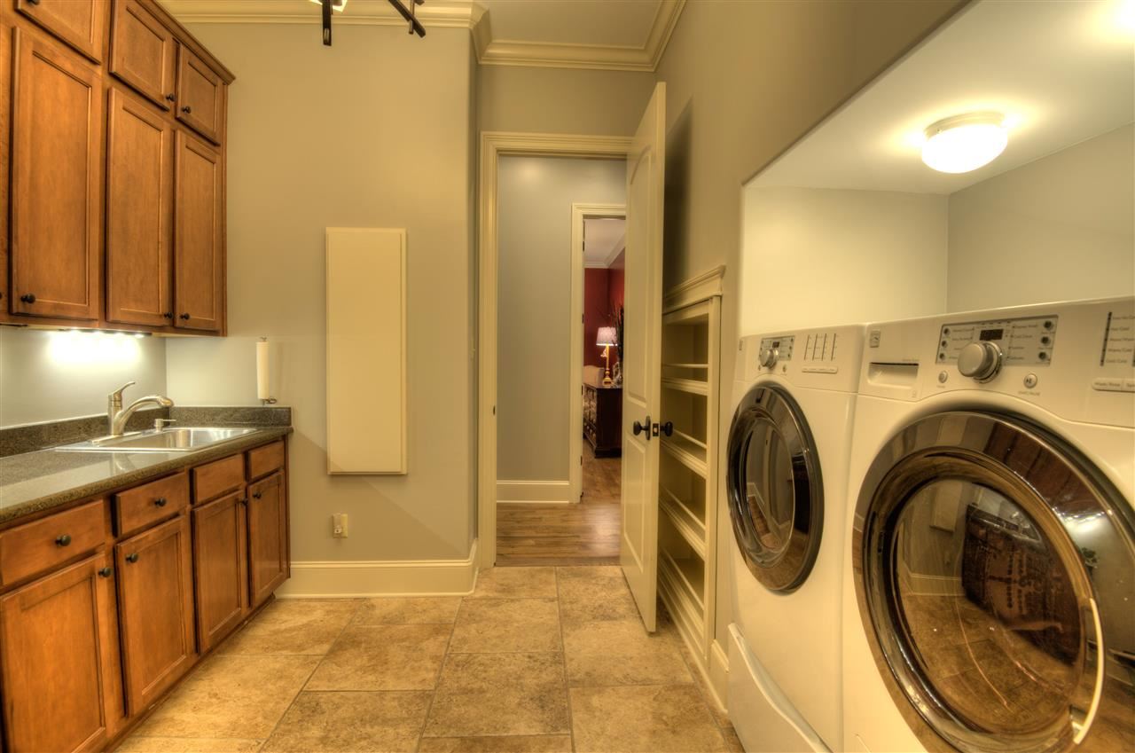 1277 South Dubray Place Collierville, TN 38017 - Photo 11 of 25 The oversized laundry room has a built in ironing board, cabinets, work sink plus space for an extra refrigerator.
