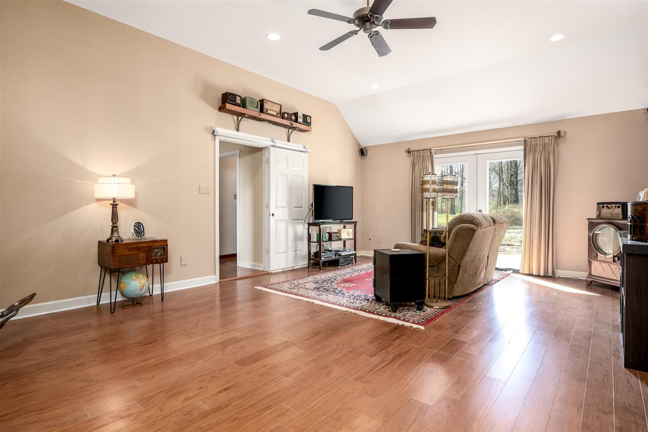 6992 7th Road Bartlett, TN 38135 - Photo 13 of 25 Beautiful hardwood floor in this room. Has an attached Bathroom. Can be a downstairs master (there is another master bedoom upstairs) OR can make a fantastic media room or a great place to put your pool table. Doors lead onto a stone patio.
