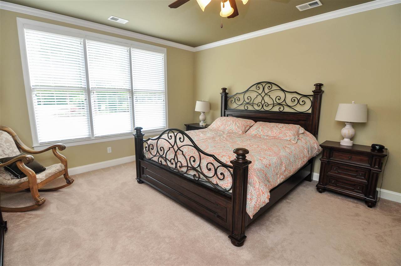 345 Windover Road Piperton, TN 38017 - Photo 11 of 25 The master suite is located downstairs and enjoys vaulted ceilings with fan, carpet, large window, crown molding, and private full bath.