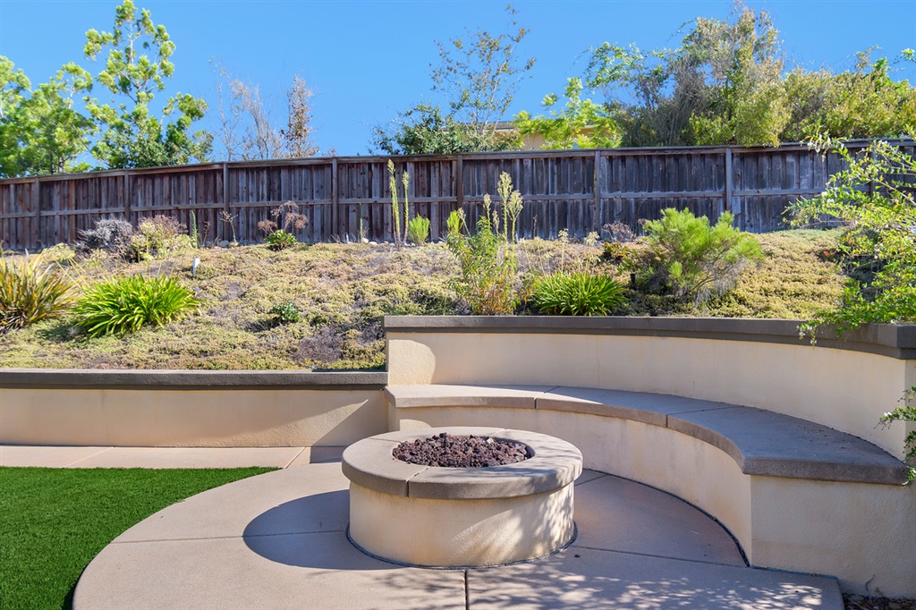 14449 Whispering Ridge Road San Diego, CA 92131 - Photo 25 of 25 Gas fire pit with custom seating add to fun and relaxing ambiance of the backyard.