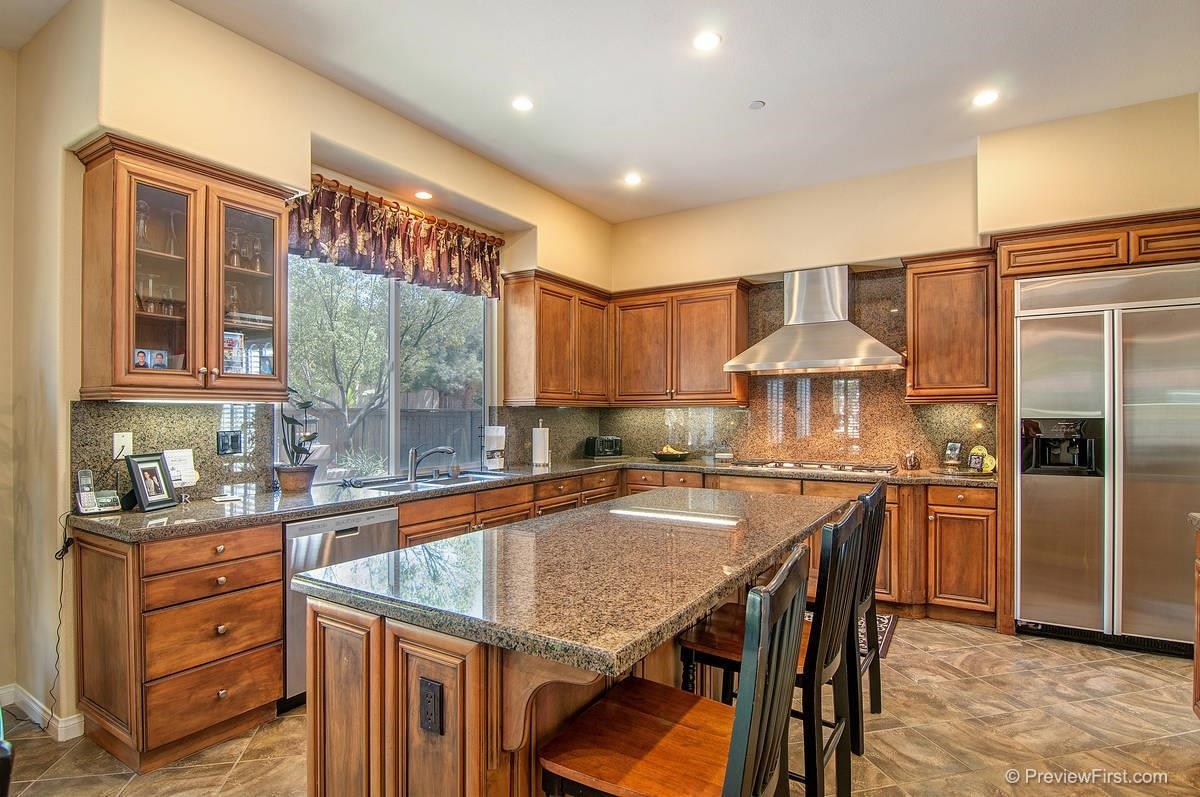 16325 Deer Ridge Road San Diego, CA 92127 - Photo 9 of 25 With views to the back yard, this kitchen is light & bright w/plenty of ceiling lights and under counter lighting. Chef's delight w/SS appliances, 6 burner gas cooktop, SS hood, slab granite counters, center island w/breakfast bar and walk-in pantry.