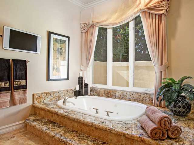 17036 Circa Del Sur Rancho Santa Fe, CA 92067 - Photo 11 of 25 The master tub also has been artfully trimmed with granite, custom drapes and moldings.