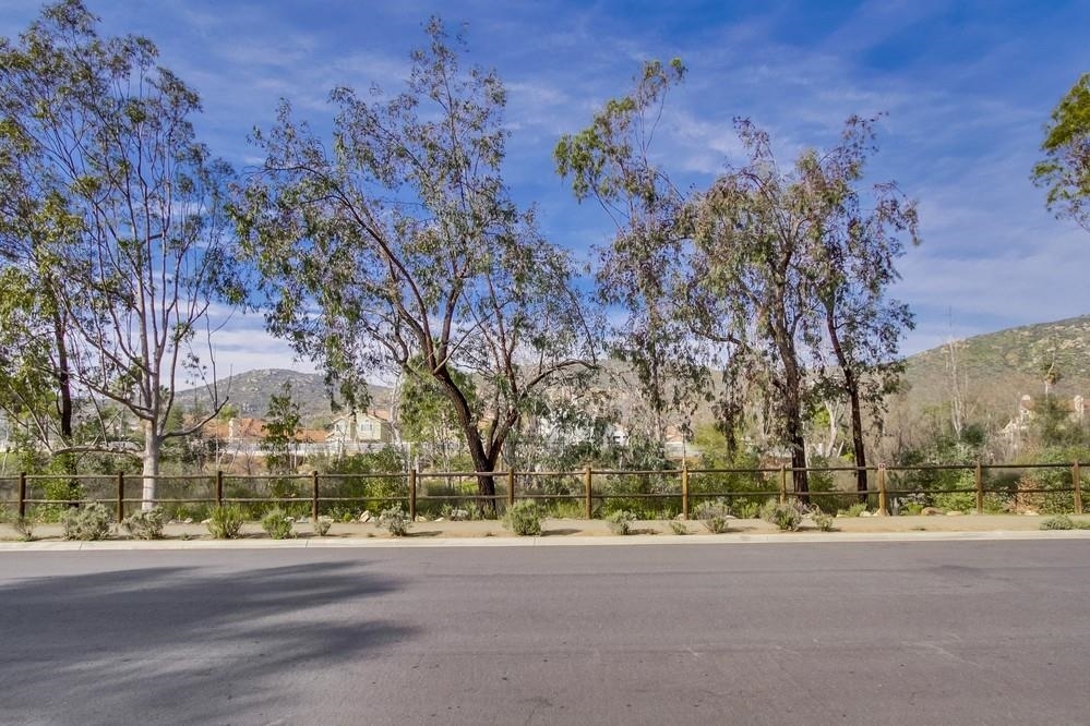 15185 Garden Road Poway, CA 92064 - Photo 22 of 25 Not to be outdone by the private backyard, a beautiful open space with creek and large sycamore trees line the front of this home.