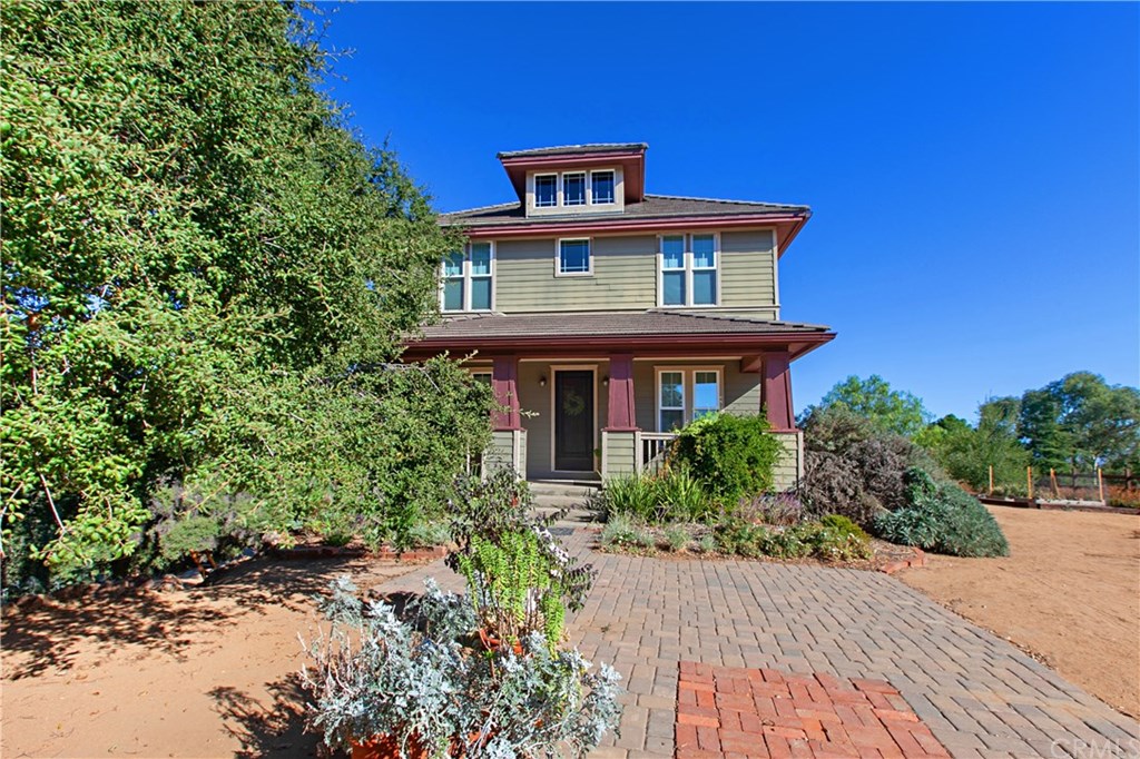Beautifully paved flower lined path to the home which is surrounded by Gardens, Berry Bushes and Fruit Trees.