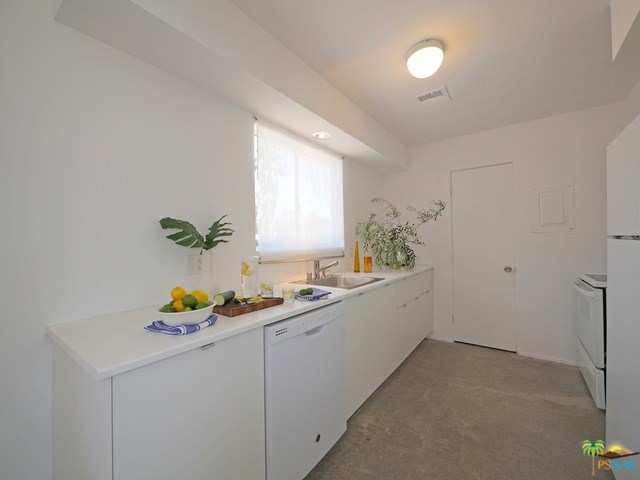 277 East Racquet Club Road Palm Springs, CA 92262 - Photo 8 of 25 Galley kitchen with pantry and full size range