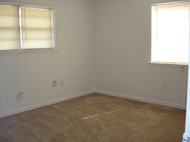 985 Liberty Road Moscow, TN 38057 - Photo 5 of 5 Partial view of the Master Bedroom that has a nice size closet with wooden shelving. New Blinds, New Carpet, New Paint and more!