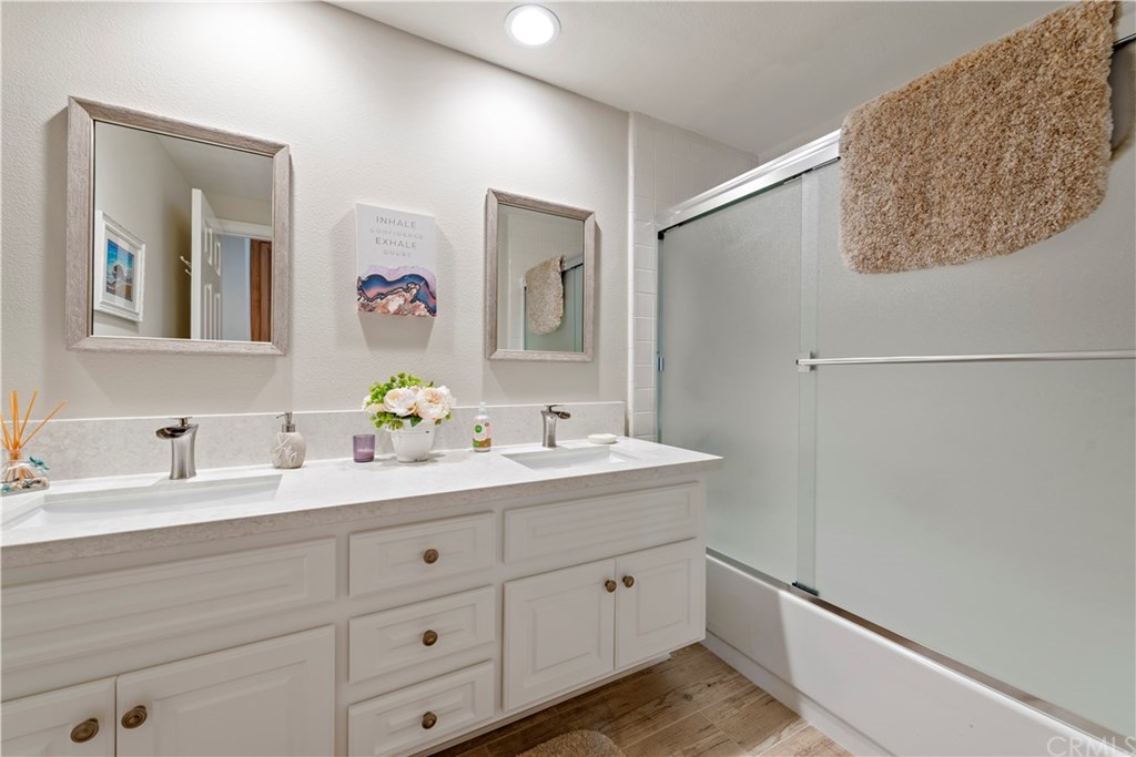 2152 Vallejo Drive Tustin, CA 92782 - Photo 27 of 35 Upstairs hall bath - upgraded vanity quartz counters, dual sinks & upgraded wood like tile flooring.