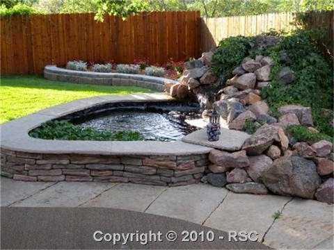 649 Paradise Lane Colorado Springs, CO 80904 - Photo 9 of 13 Completely landscaped & fenced backyard with mature Koi in pond/water feature.