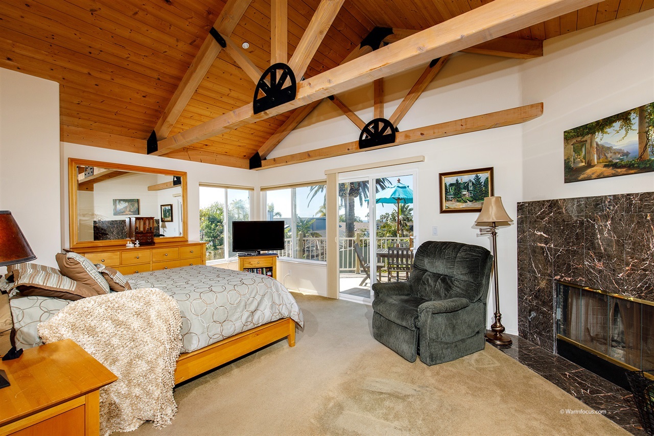 449 Ocean View Avenue Encinitas, CA 92024 - Photo 11 of 23 Fireplace and exposed beam ceilings in the ocean-view master suite