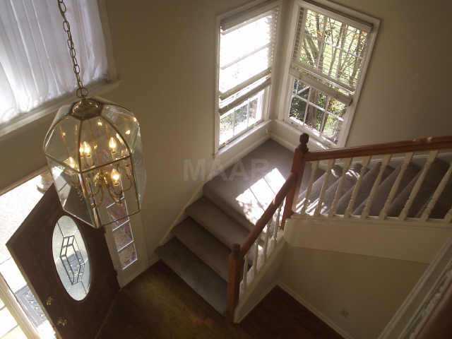 760 Shelton Road Collierville, TN 38017 - Photo 1 of 10 Second floor balcony overlooks the Inviting Foyer with hardwood floors, lead glass door, large cathedral-style window, and chandelier lighting. Half bath is conveniently located off this area.