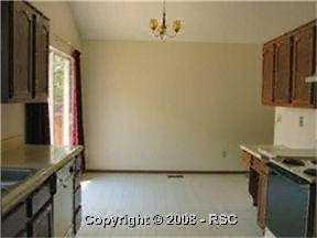Looking from the Kitchen toward the Dining Area. Access the cement patio and large fenced yard through the newer vinyl clad double pane sliding door.