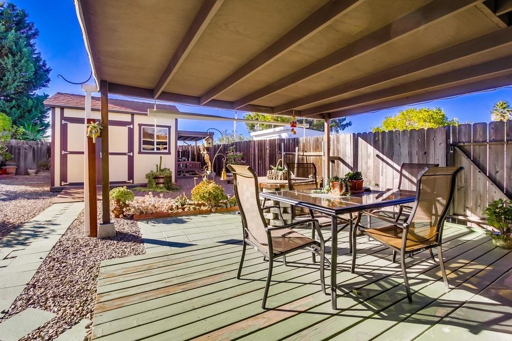 1399 Panorama Ridge Road Oceanside, CA 92056 - Photo 22 of 25 Patio has covered portions on both back and side, then a very generously sized uncovered area with fruit trees, succulents & even blueberry bushes