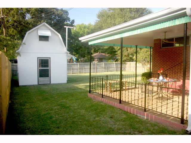 4844 Amboy Road Memphis, TN 38117 - Photo 11 of 12 Covered Patio overlooks a large, wood-fenced back yard. Concrete storage shed includes permanent stairs to floored storage.