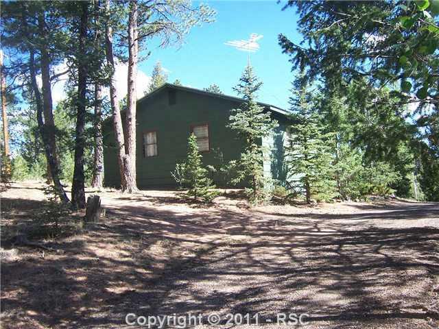 2126 Upper Twin Rocks Road Florissant, CO 80816 - Photo 1 of 14 Enchanting Forest, Set Back From Road. Asphalt Drive Leads to House.