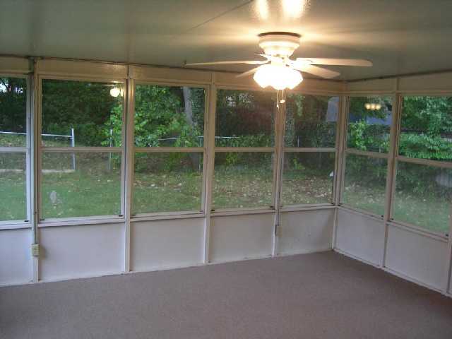 3305 Coleman Road Memphis, TN 38128 - Photo 5 of 7 Glassed in sunroom with new flooring, NEW ceiling fan, and AC unit.