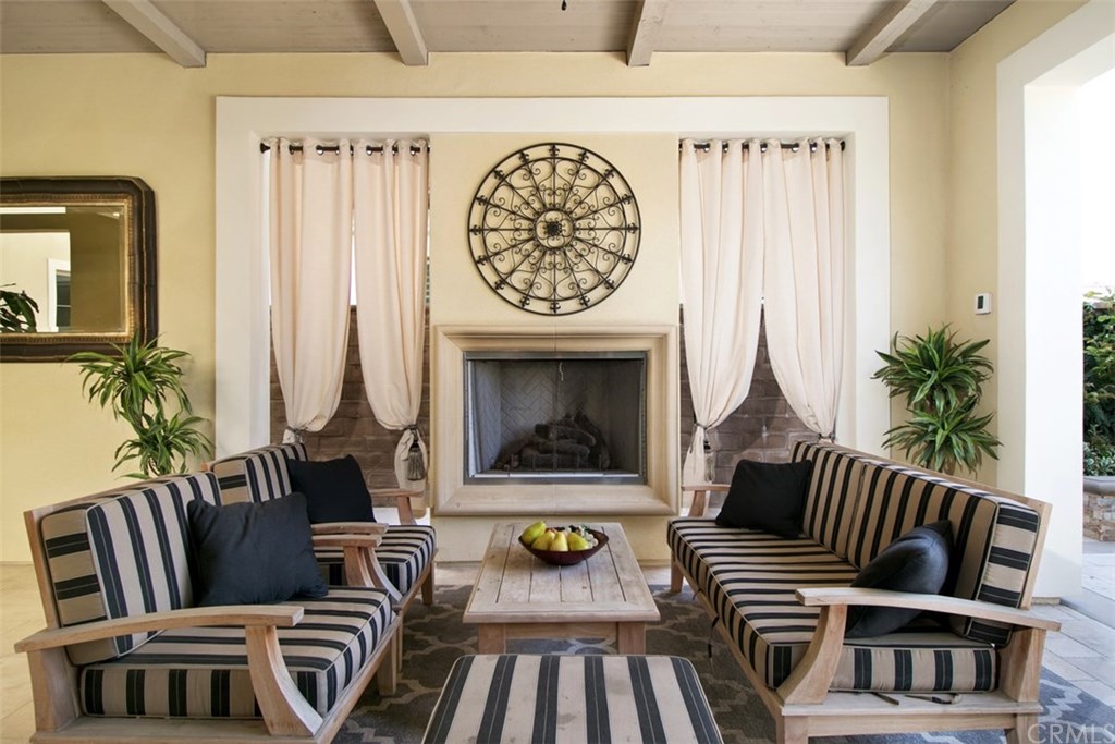 17 Rawhide Irvine, CA 92602 - Photo 10 of 56 Outdoor living room area has beautiful grand fireplace that follows into indoor great room.