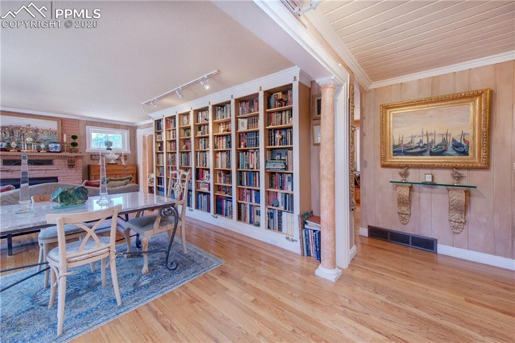 7955 Highway 24 Cascade, CO 80809 - Photo 5 of 36 Main level living room features a wall of built-in bookshelves