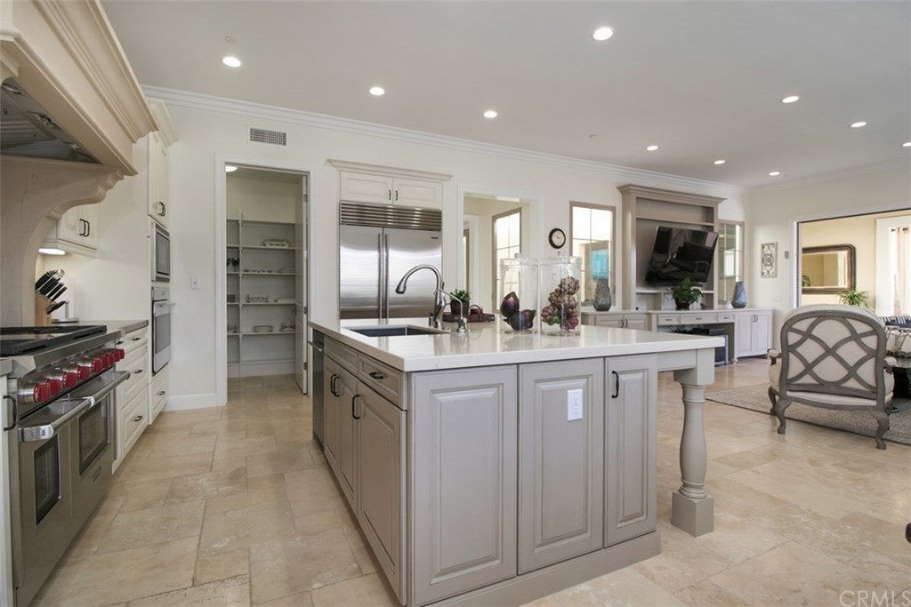 17 Rawhide Irvine, CA 92602 - Photo 7 of 56 Light and bright kitchen with caesarstone island with barstool seating. High-grade painted and glazed cabinetry, gorgeous decorative backsplash, with plenty of countertop and storage, including walk-in pantry. Top of the line stainless steel wolf and sub-zero kitchen appliances.