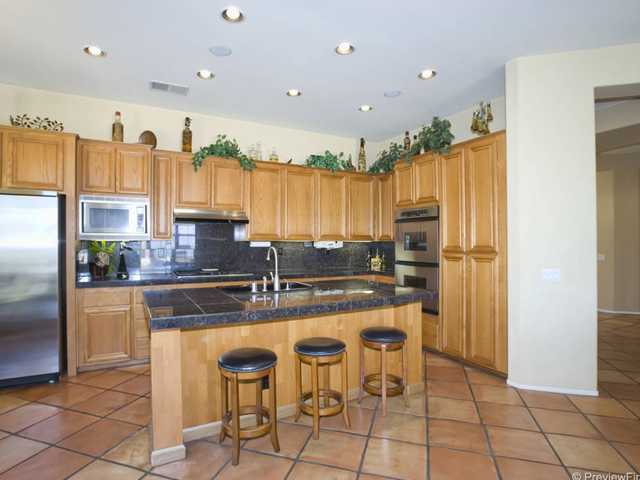 1668 La Force Road Alpine, CA 91901 - Photo 14 of 25 Gourmet kitchen with a center island/bar, granite counter tops, stainless steel appliances, recessed lighting, clay tile flooring, tons of cabinet space & views of the peaceful Alpine mountains and hills.